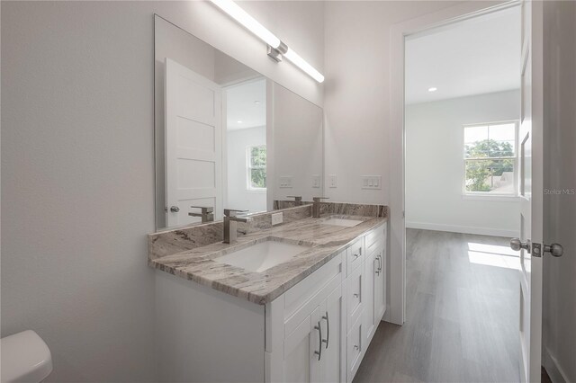 5530 N 9th St Unit 6, Tampa, FL 33604 - bathroom with double vanity, wood finished floors, toilet, and recessed lighting
