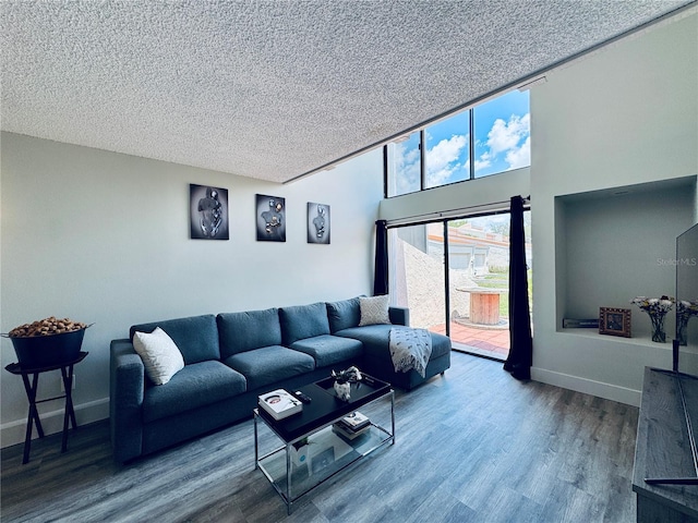 4360 Outrigger Ln, Tampa, FL 33615 - living room with wood finished floors, a textured ceiling, and baseboards