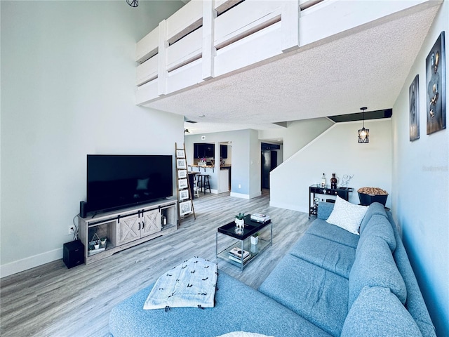 4360 Outrigger Ln, Tampa, FL 33615 - living area with wood finished floors, baseboards, and a textured ceiling