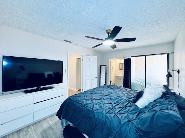 4360 Outrigger Ln, Tampa, FL 33615 - bedroom with light wood finished floors, a textured ceiling, a ceiling fan, and ensuite bath