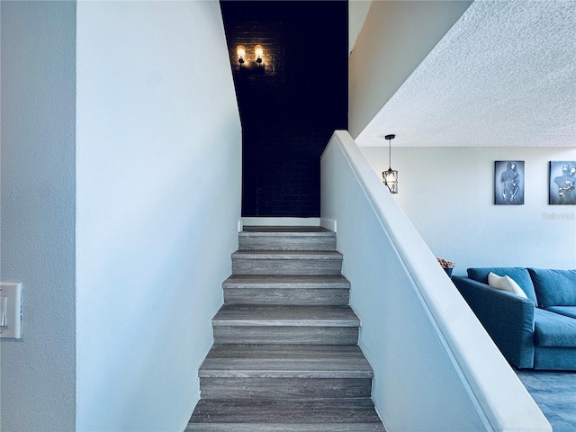 4360 Outrigger Ln, Tampa, FL 33615 - staircase featuring wood finished floors and a textured ceiling
