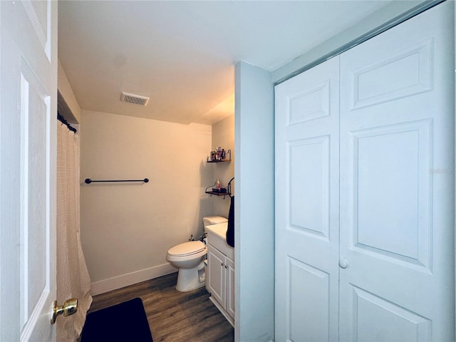 4360 Outrigger Ln, Tampa, FL 33615 - bathroom featuring wood finished floors, vanity, toilet, baseboards, and a shower with shower curtain