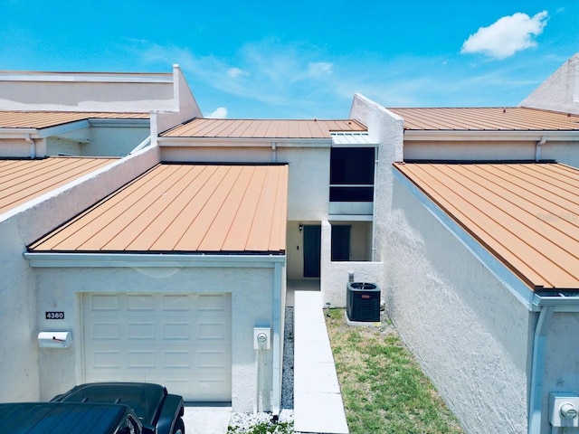 4360 Outrigger Ln, Tampa, FL 33615 - view of front of property with a standing seam roof, metal roof, stucco siding, and a garage
