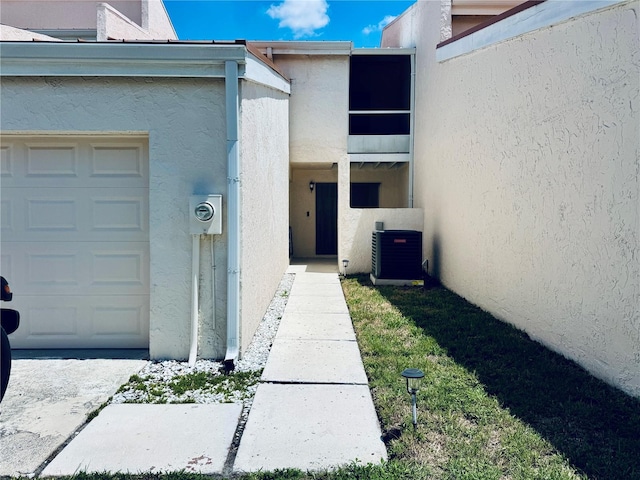 4360 Outrigger Ln, Tampa, FL 33615 - entrance to property featuring cooling unit and stucco siding