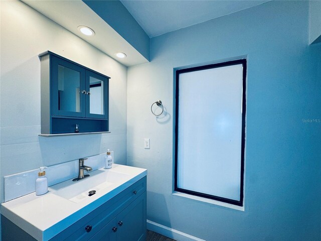 4360 Outrigger Ln, Tampa, FL 33615 - bathroom featuring vanity, recessed lighting, baseboards, and wood finished floors