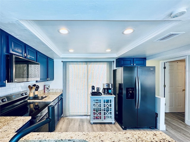 4360 Outrigger Ln, Tampa, FL 33615 - kitchen with appliances with stainless steel finishes, light wood-style flooring, blue cabinets, ornamental molding, and recessed lighting