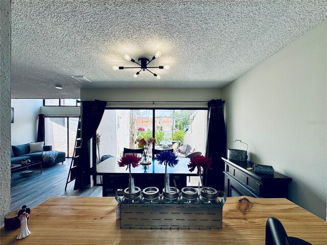 4360 Outrigger Ln, Tampa, FL 33615 - dining room with wood finished floors and a textured ceiling