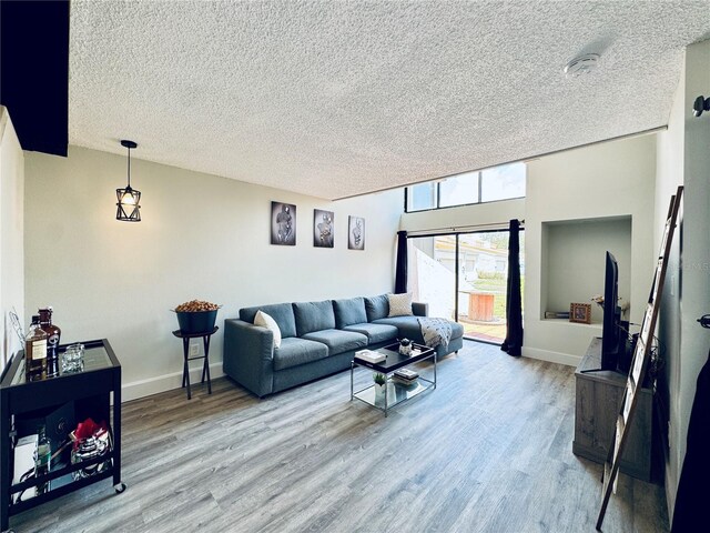 4360 Outrigger Ln, Tampa, FL 33615 - living room with a textured ceiling, wood finished floors, and baseboards