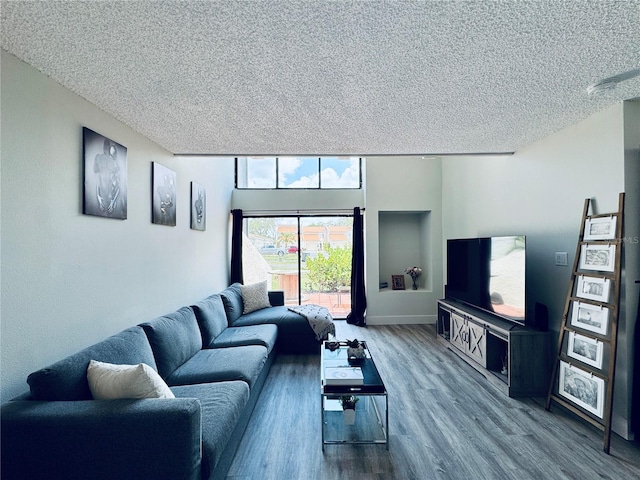 4360 Outrigger Ln, Tampa, FL 33615 - living room with a textured ceiling, wood finished floors, and baseboards