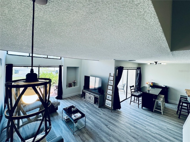 4360 Outrigger Ln, Tampa, FL 33615 - living area with wood finished floors, a textured ceiling, and baseboards