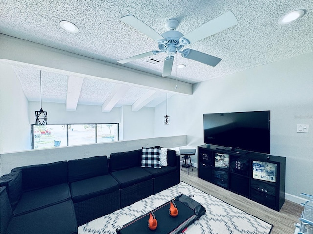 4360 Outrigger Ln, Tampa, FL 33615 - living area with wood finished floors, ceiling fan, beam ceiling, and a textured ceiling