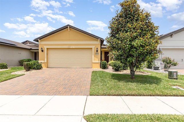 472 Pontevedra Rd, Davenport, FL 33837 - ranch-style home with an attached garage, decorative driveway, a front lawn, and stucco siding