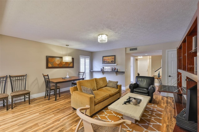 3053 S Concordia Ave Unit A, Tampa, FL 33629 - living area with wood finished floors, a textured ceiling, and baseboards