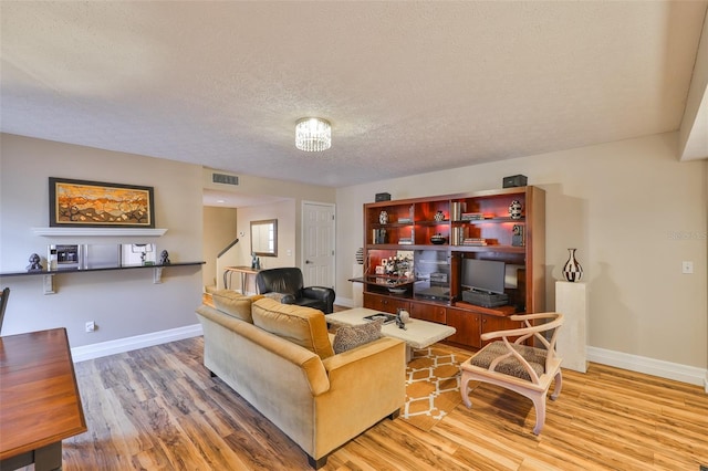 3053 S Concordia Ave Unit A, Tampa, FL 33629 - living area with a textured ceiling, wood finished floors, baseboards, and stairs