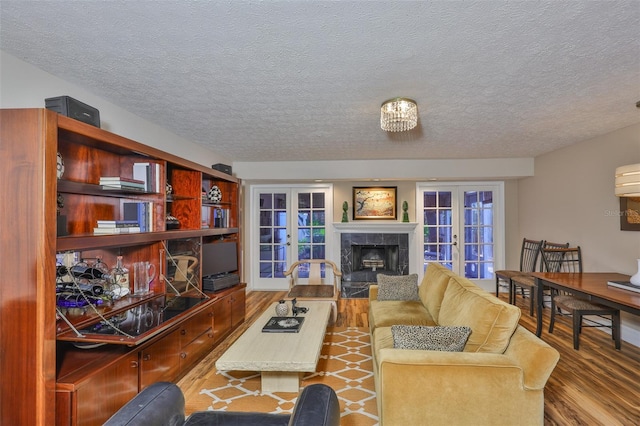 3053 S Concordia Ave Unit A, Tampa, FL 33629 - living room with a premium fireplace, wood finished floors, french doors, and a textured ceiling