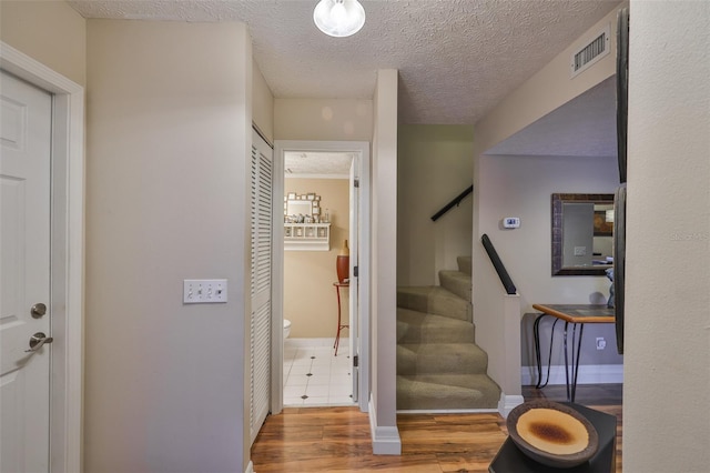 3053 S Concordia Ave Unit A, Tampa, FL 33629 - foyer entrance with wood finished floors, stairs, baseboards, and a textured ceiling