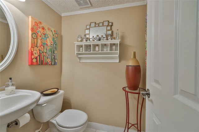 3053 S Concordia Ave Unit A, Tampa, FL 33629 - bathroom featuring crown molding, a textured ceiling, toilet, and tile patterned flooring
