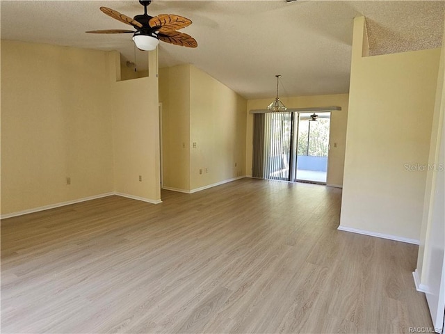 870 S Thyme Pt, Homosassa, FL 34448 - empty room featuring ceiling fan, baseboards, light wood finished floors, a textured ceiling, and lofted ceiling
