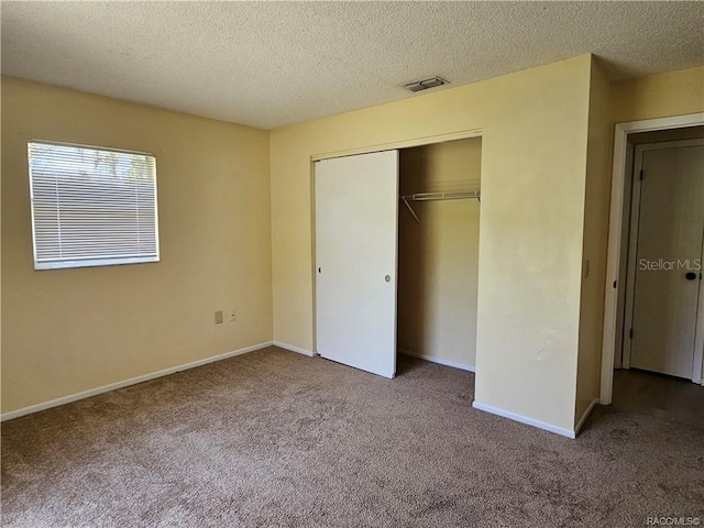 870 S Thyme Pt, Homosassa, FL 34448 - unfurnished bedroom featuring carpet flooring, a closet, a textured ceiling, and baseboards