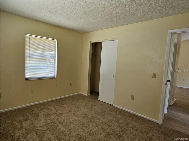 870 S Thyme Pt, Homosassa, FL 34448 - unfurnished bedroom featuring carpet flooring, a closet, baseboards, and a textured ceiling