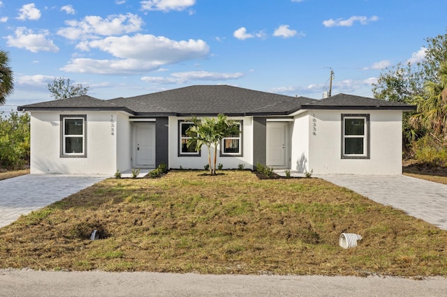 12047 Henley Ave, Port Charlotte, FL 33981 - view of front of property featuring a front yard and stucco siding