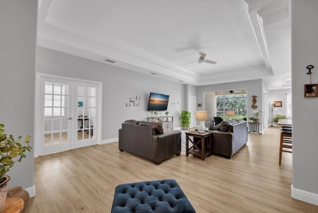 8223 Haven Harbour Way, Bradenton, FL 34212 - living area with a raised ceiling, ceiling fan, and light wood-style flooring