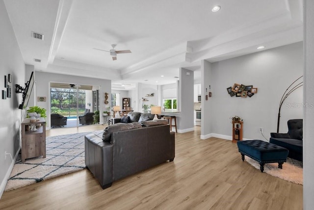8223 Haven Harbour Way, Bradenton, FL 34212 - living room featuring a raised ceiling, ceiling fan, light wood-style flooring, and recessed lighting