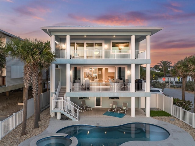 2 Gulf Blvd, Indian Rocks Beach, FL 33785 - rear view of house featuring a balcony, a fenced backyard, stairway, and a patio