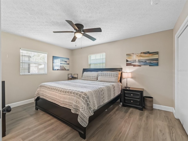 718 Crk 467, Lake Panasoffkee, FL 33538 - bedroom with baseboards, wood finished floors, a textured ceiling, and ceiling fan