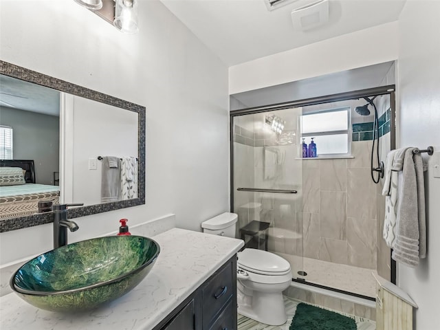 718 Crk 467, Lake Panasoffkee, FL 33538 - ensuite bathroom with a stall shower, vanity, healthy amount of natural light, and toilet
