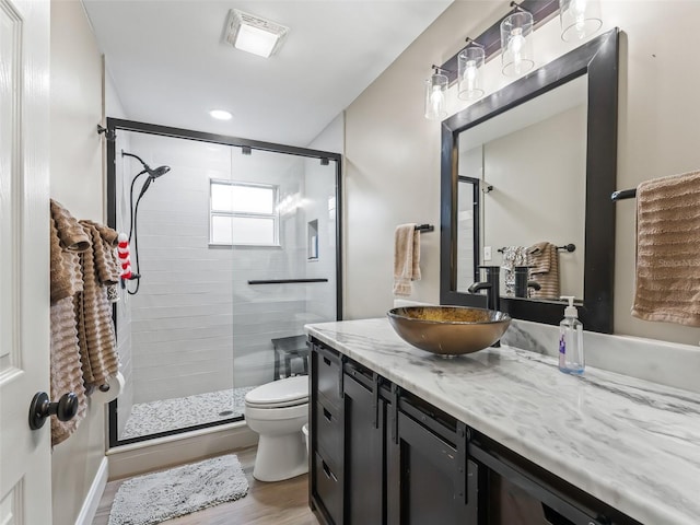 718 Crk 467, Lake Panasoffkee, FL 33538 - full bath with vanity, toilet, a shower stall, wood finished floors, and recessed lighting