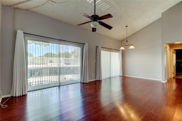 2932 Lichen Ln Unit D, Clearwater, FL 33760 - spare room featuring a ceiling fan, wood finished floors, baseboards, high vaulted ceiling, and a textured ceiling