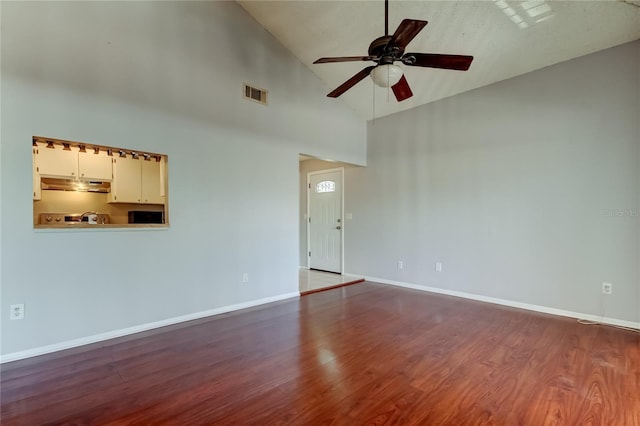 2932 Lichen Ln Unit D, Clearwater, FL 33760 - empty room featuring a ceiling fan, high vaulted ceiling, wood finished floors, and baseboards