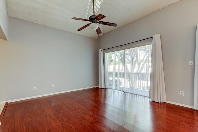 2932 Lichen Ln Unit D, Clearwater, FL 33760 - empty room with wood finished floors, a ceiling fan, baseboards, and a textured ceiling
