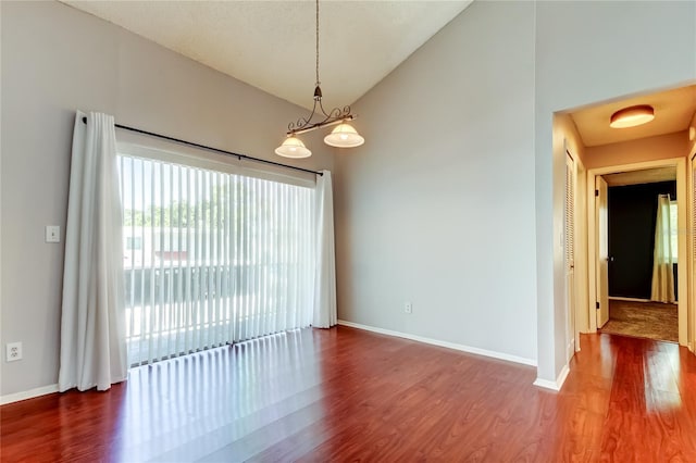 2932 Lichen Ln Unit D, Clearwater, FL 33760 - unfurnished room with wood finished floors, vaulted ceiling, and baseboards
