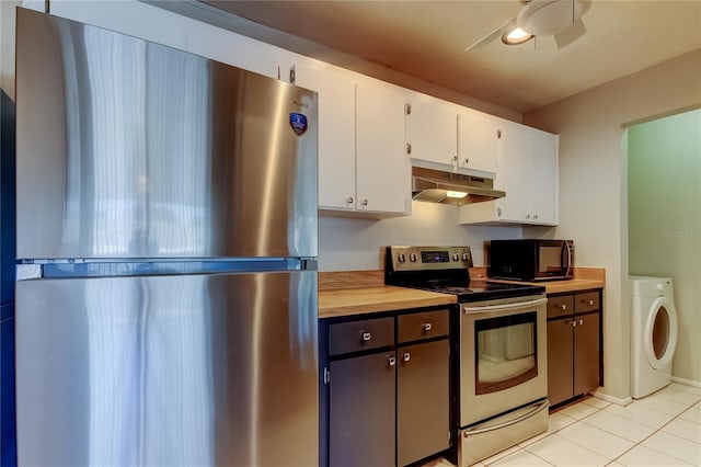 2932 Lichen Ln Unit D, Clearwater, FL 33760 - kitchen featuring stainless steel appliances, under cabinet range hood, washer / clothes dryer, white cabinetry, and light tile patterned floors