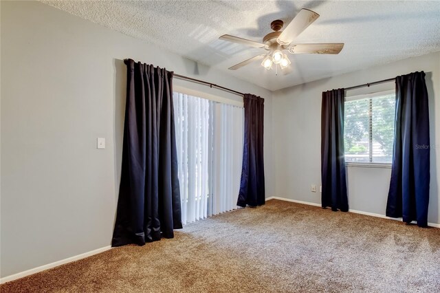 2932 Lichen Ln Unit D, Clearwater, FL 33760 - carpeted spare room with a ceiling fan, a textured ceiling, and baseboards