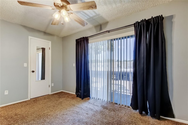 2932 Lichen Ln Unit D, Clearwater, FL 33760 - spare room featuring carpet, a ceiling fan, baseboards, and a textured ceiling