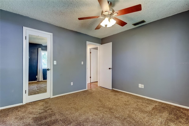 2932 Lichen Ln Unit D, Clearwater, FL 33760 - unfurnished bedroom with carpet, a textured ceiling, baseboards, and a ceiling fan