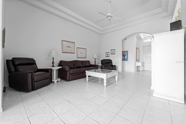 1130 Hominy Hill Dr, Trinity, FL 34655 - living room with arched walkways, a high ceiling, light tile patterned floors, ceiling fan, and a raised ceiling