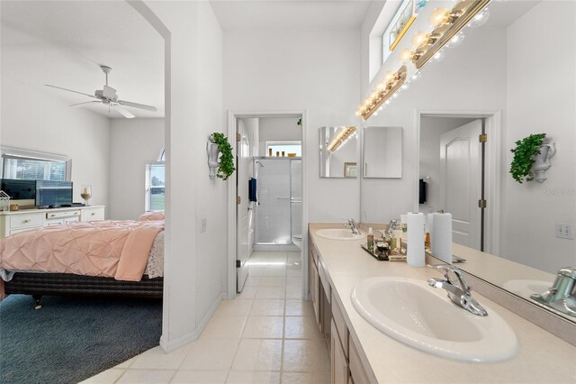 1130 Hominy Hill Dr, Trinity, FL 34655 - full bathroom featuring ensuite bath, double vanity, tile patterned floors, a stall shower, and a ceiling fan