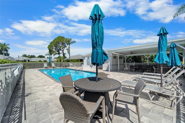 1130 Hominy Hill Dr, Trinity, FL 34655 - community pool with a patio, outdoor dining area, and a ceiling fan