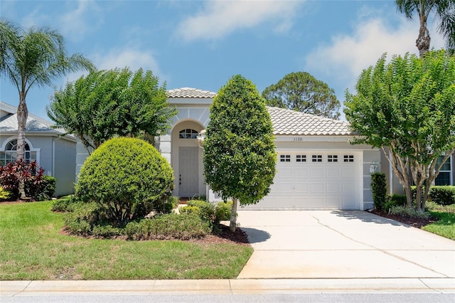 1130 Hominy Hill Dr, Trinity, FL 34655 - mediterranean / spanish-style home with a tiled roof, an attached garage, concrete driveway, and stucco siding