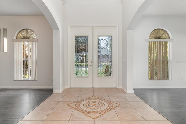 239 Beacon Pointe Dr, Ocoee, FL 34761 - foyer featuring wood finished floors, arched walkways, and baseboards