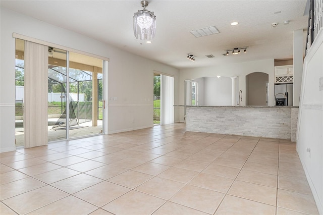 239 Beacon Pointe Dr, Ocoee, FL 34761 - unfurnished room with light tile patterned flooring, arched walkways, recessed lighting, and baseboards