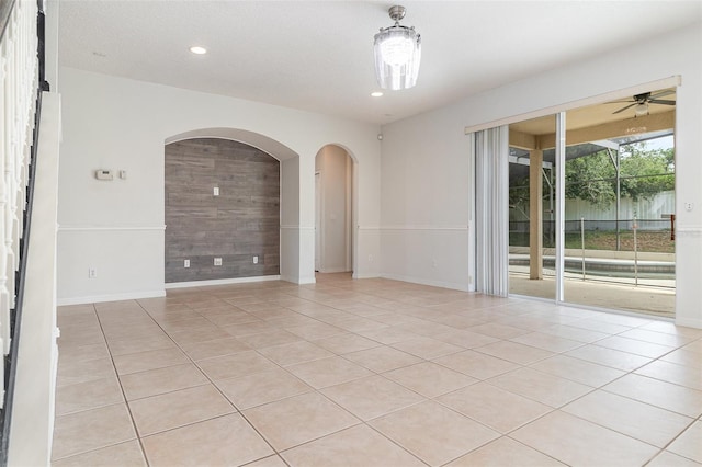 239 Beacon Pointe Dr, Ocoee, FL 34761 - spare room featuring a ceiling fan, light tile patterned floors, baseboards, arched walkways, and recessed lighting