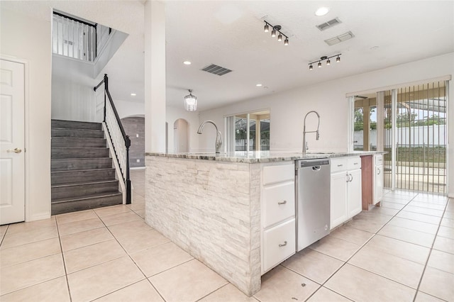 239 Beacon Pointe Dr, Ocoee, FL 34761 - kitchen featuring dishwasher, a sink, light tile patterned flooring, white cabinets, and light stone countertops