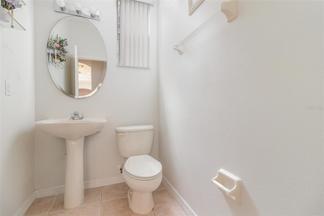 239 Beacon Pointe Dr, Ocoee, FL 34761 - bathroom featuring toilet, tile patterned floors, and baseboards