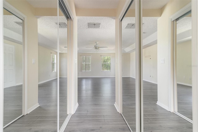 239 Beacon Pointe Dr, Ocoee, FL 34761 - corridor featuring healthy amount of natural light, wood finished floors, a textured ceiling, and baseboards