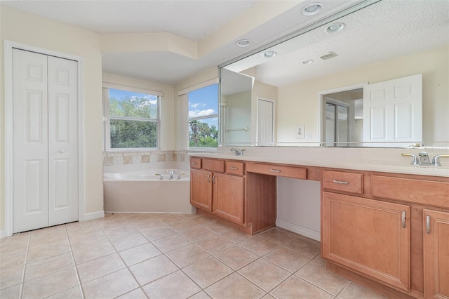239 Beacon Pointe Dr, Ocoee, FL 34761 - full bathroom featuring double vanity, a closet, a bath, tile patterned floors, and a textured ceiling